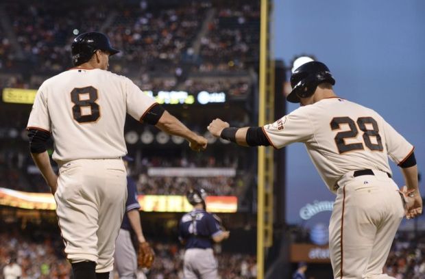 April 29, 2014; San Francisco, CA, USA; San Francisco Giants right fielder Hunter Pence (8) and first baseman Buster Posey (28) celebrate after both scored on a two-RBI single by catcher Hector Sanchez (29, not pictured) against the San Diego Padres during the third inning at AT&T Park. Mandatory Credit: Kyle Terada-USA TODAY Sports